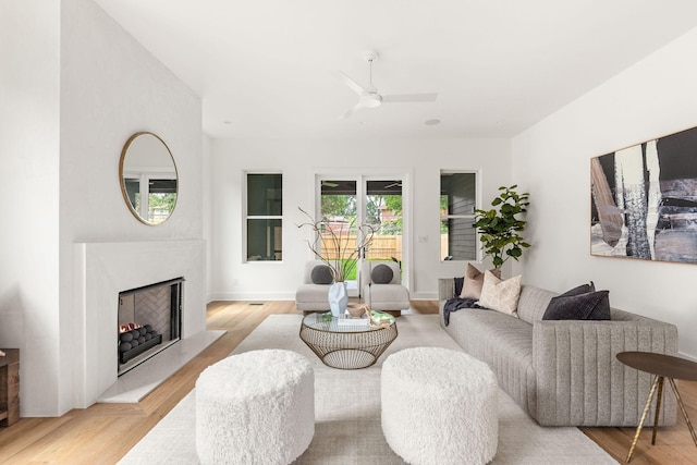 living room featuring ceiling fan and light hardwood / wood-style floors