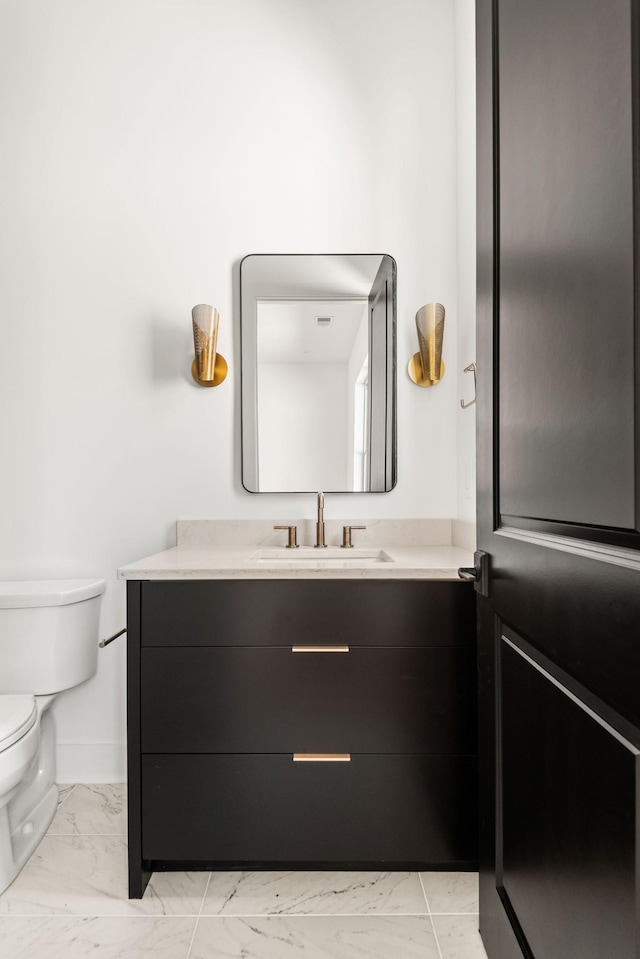 bathroom with vanity and toilet