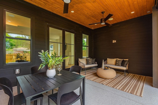 sunroom / solarium featuring ceiling fan and wood ceiling