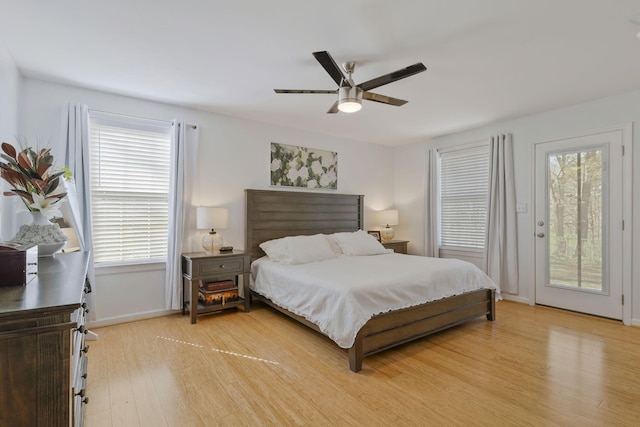 bedroom featuring ceiling fan, light hardwood / wood-style floors, and access to outside