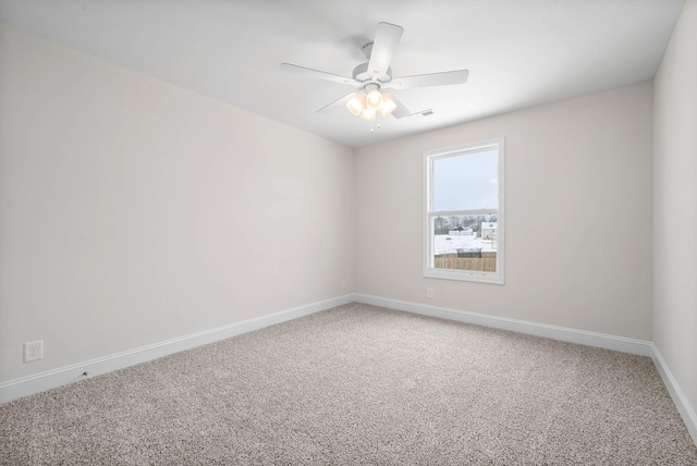 spare room featuring ceiling fan and carpet