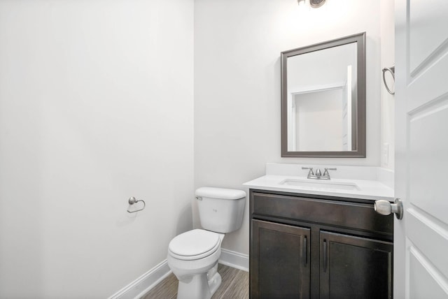 bathroom with vanity, hardwood / wood-style floors, and toilet