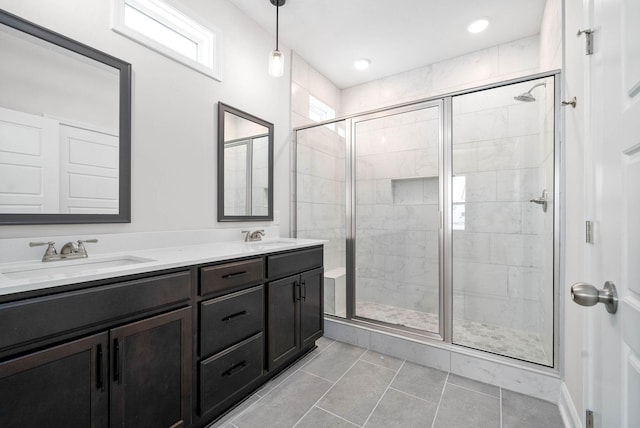 bathroom featuring vanity and a shower with door