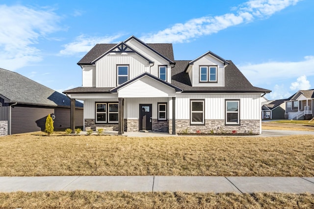 view of front of property with covered porch and a front lawn