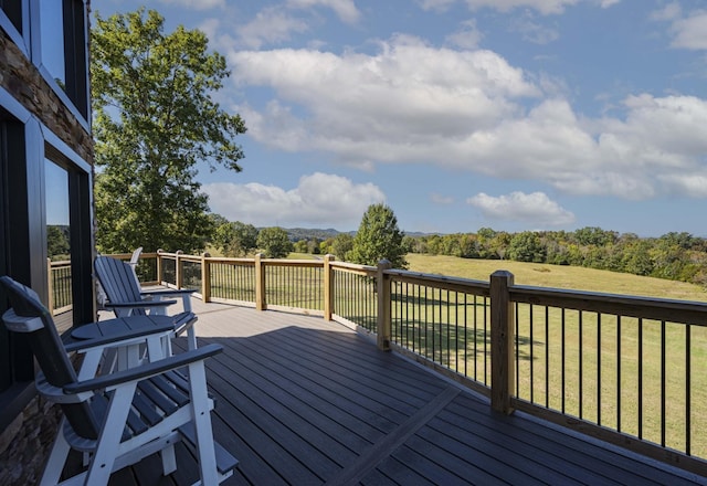 wooden terrace with a lawn