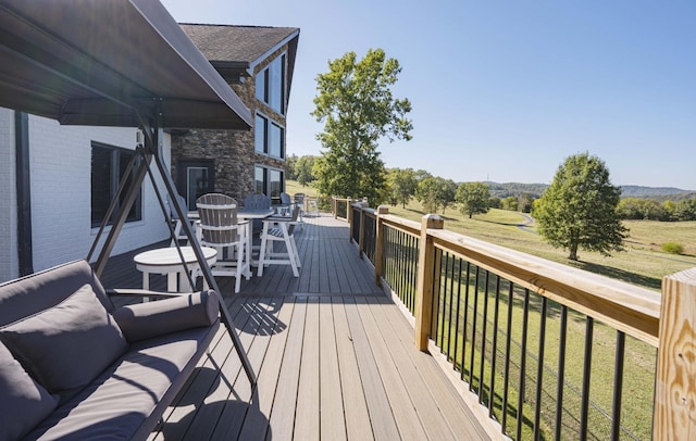 wooden deck featuring a yard