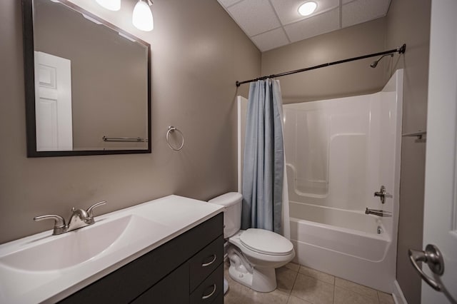 full bathroom featuring shower / bath combo, a drop ceiling, vanity, tile patterned flooring, and toilet