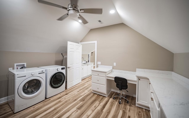 laundry room with cabinets, sink, light hardwood / wood-style flooring, ceiling fan, and independent washer and dryer