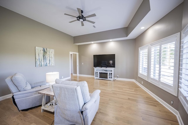 living room featuring ceiling fan and light wood-type flooring