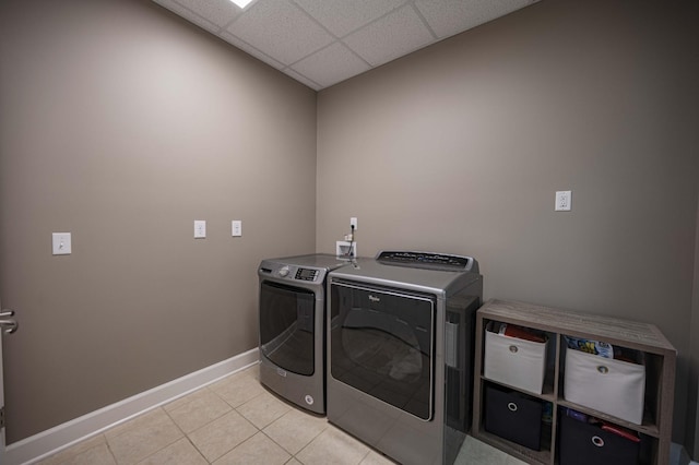 clothes washing area with separate washer and dryer and light tile patterned floors