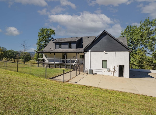 back of property featuring a patio, cooling unit, and a lawn