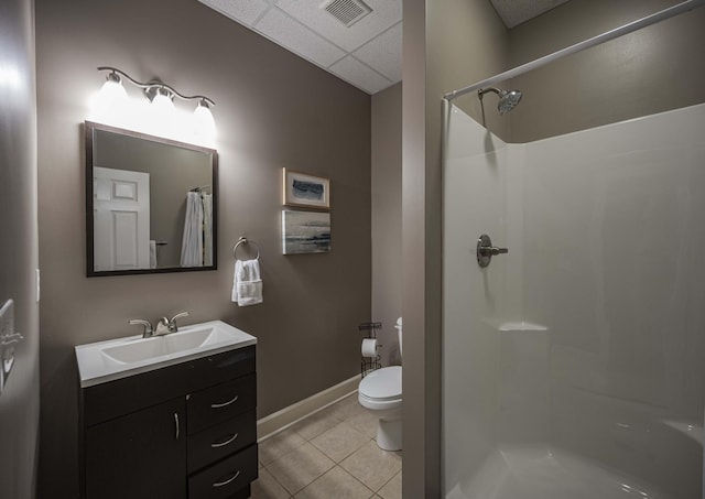 bathroom with walk in shower, tile patterned flooring, toilet, a paneled ceiling, and vanity