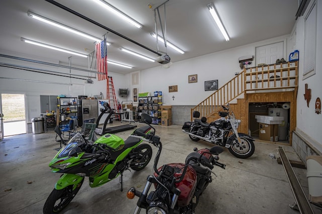 garage featuring stainless steel fridge with ice dispenser and a garage door opener