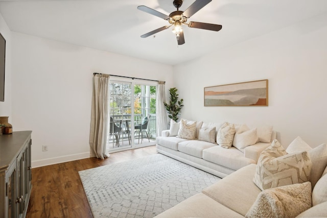 living room with ceiling fan and dark hardwood / wood-style flooring