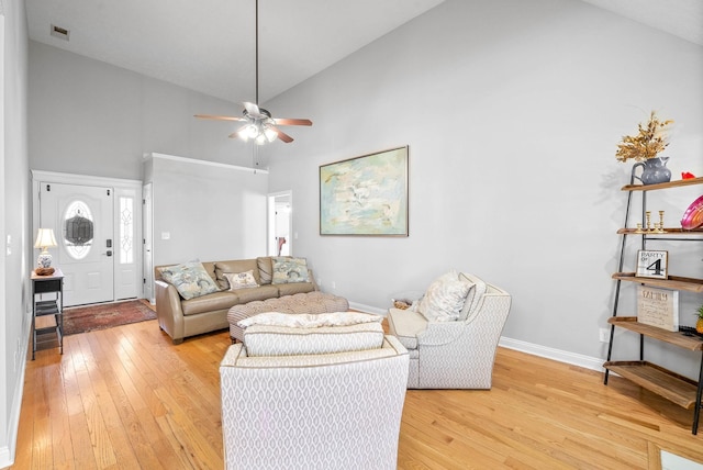 living room featuring wood-type flooring, high vaulted ceiling, and ceiling fan