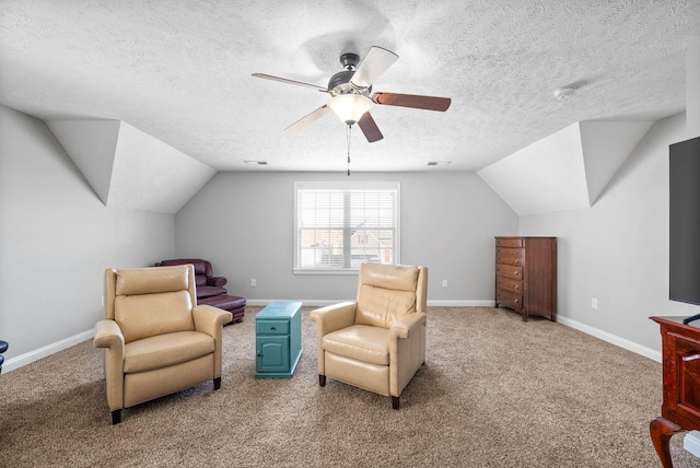 living area featuring a textured ceiling, carpet flooring, and lofted ceiling