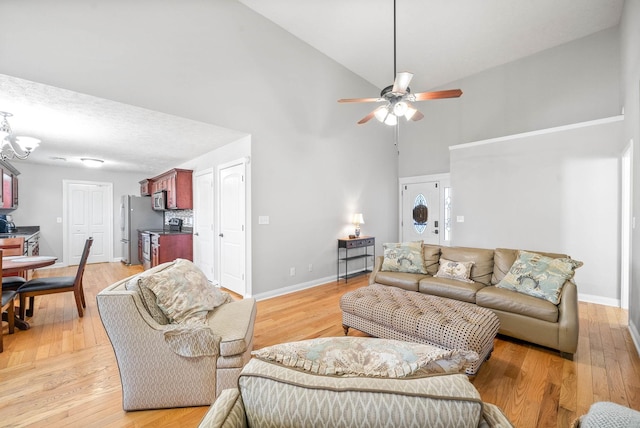 living room with ceiling fan, high vaulted ceiling, and light wood-type flooring