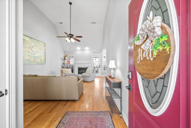 living room with hardwood / wood-style floors, ceiling fan, and lofted ceiling