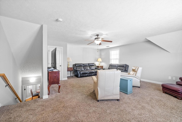 living room with carpet, a textured ceiling, and ceiling fan