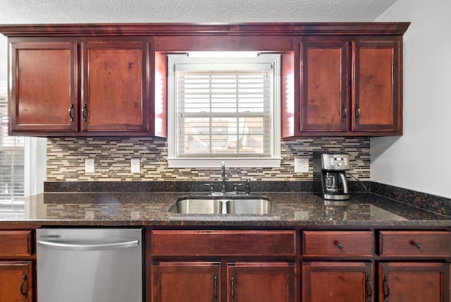 kitchen featuring stainless steel dishwasher, backsplash, dark stone countertops, and sink