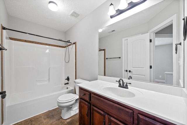 full bathroom with vanity, bathtub / shower combination, a textured ceiling, and toilet