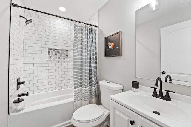 bathroom featuring shower / bathtub combination with curtain, vanity, and toilet