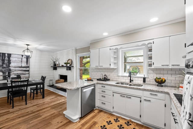 kitchen with white cabinetry, a sink, stainless steel dishwasher, and open shelves