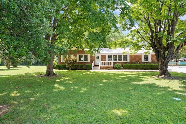 ranch-style house with a porch and a front yard