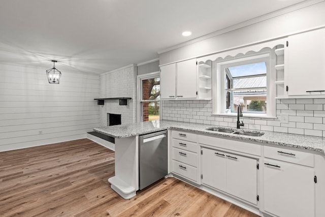 kitchen featuring light stone counters, open shelves, white cabinets, a sink, and dishwasher