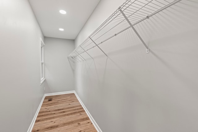 walk in closet featuring wood finished floors