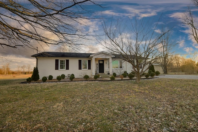 ranch-style house featuring a lawn