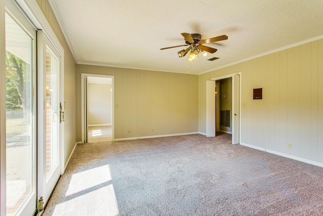 unfurnished room featuring ceiling fan, crown molding, a textured ceiling, and carpet flooring