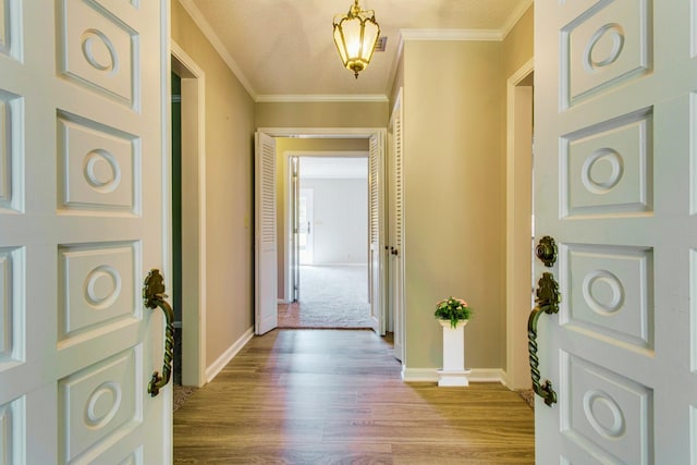 foyer entrance featuring ornamental molding and light wood-type flooring