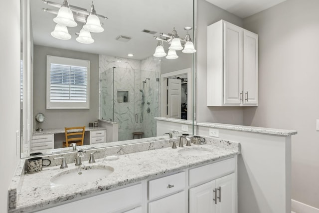 bathroom featuring vanity and an enclosed shower