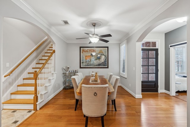 dining area with crown molding, ceiling fan, and light hardwood / wood-style floors