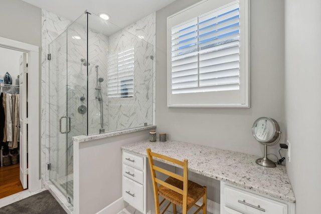 bathroom featuring a shower with door