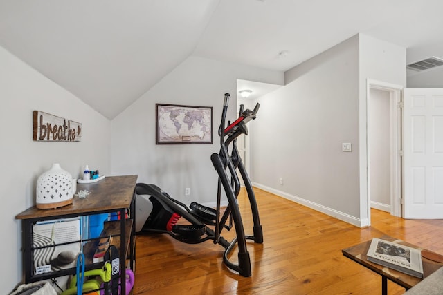 exercise area featuring lofted ceiling and wood-type flooring