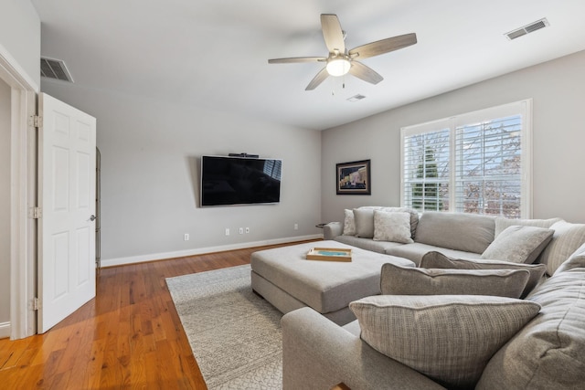 living room with ceiling fan and hardwood / wood-style flooring