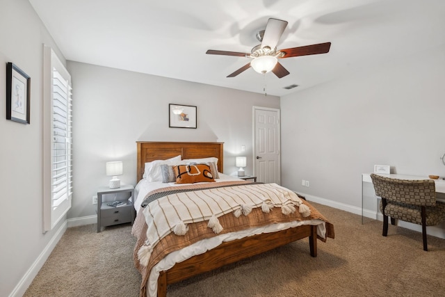 bedroom featuring multiple windows, ceiling fan, and light carpet