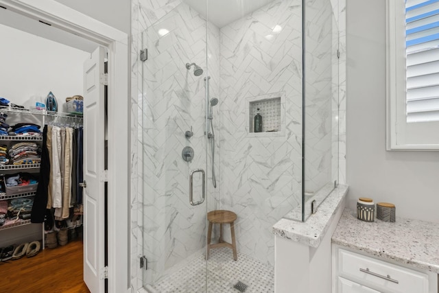 bathroom with hardwood / wood-style floors and a shower with door