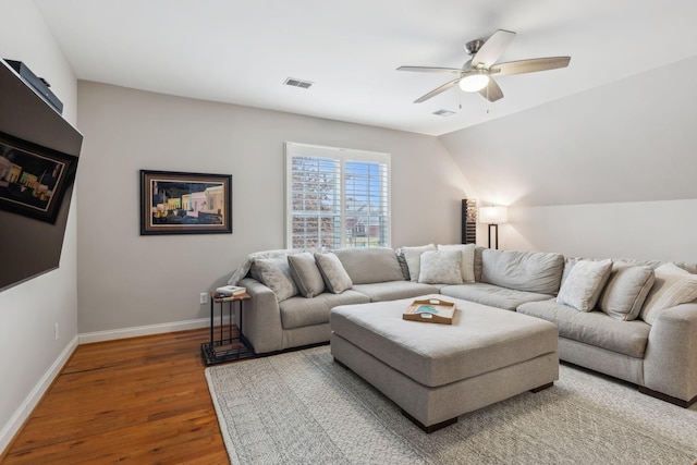 living room featuring hardwood / wood-style floors, vaulted ceiling, and ceiling fan