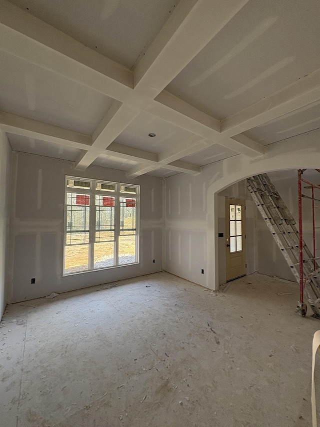 empty room featuring coffered ceiling