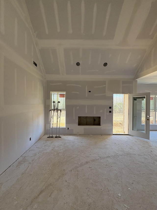 unfurnished living room featuring a high ceiling