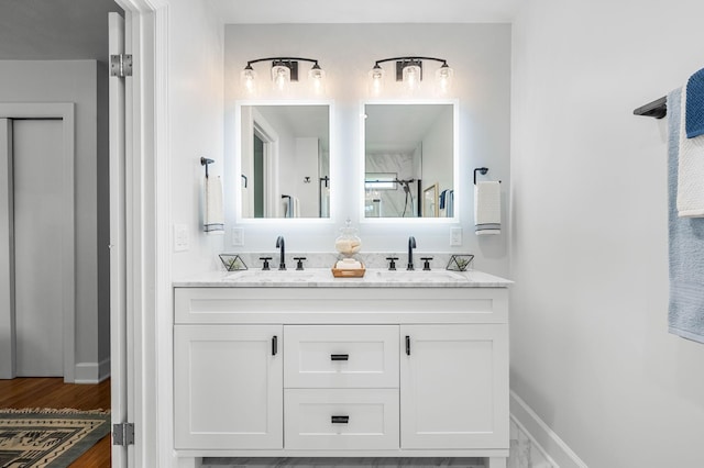 bathroom featuring vanity, wood-type flooring, and walk in shower