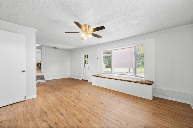 unfurnished living room with ceiling fan, light hardwood / wood-style flooring, and a textured ceiling