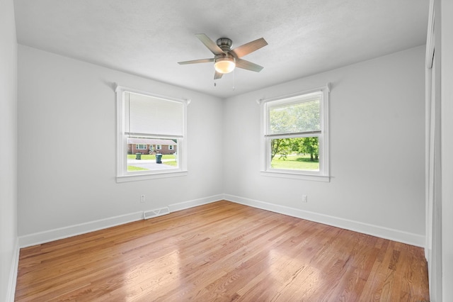 unfurnished room with light hardwood / wood-style floors and ceiling fan