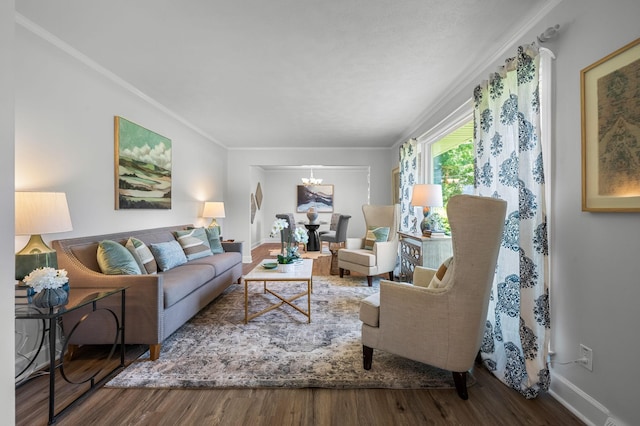 living room featuring hardwood / wood-style flooring, a chandelier, and ornamental molding