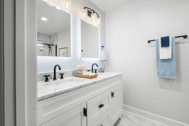 bathroom featuring a tile shower and vanity