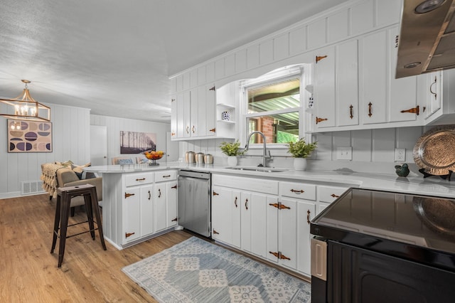 kitchen with pendant lighting, sink, stainless steel dishwasher, white cabinetry, and kitchen peninsula