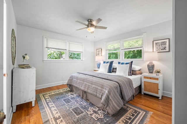 bedroom with hardwood / wood-style flooring and ceiling fan